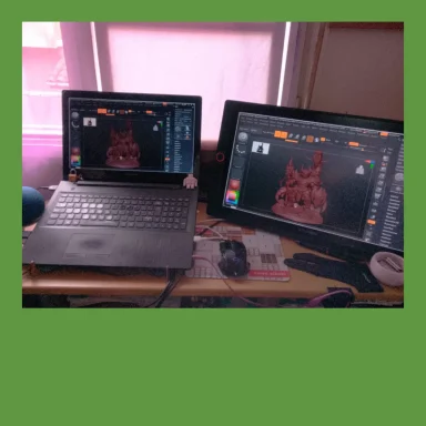 Dos pantallas de computadora en un escritorio, mostrando gráficos y herramientas de diseño.
